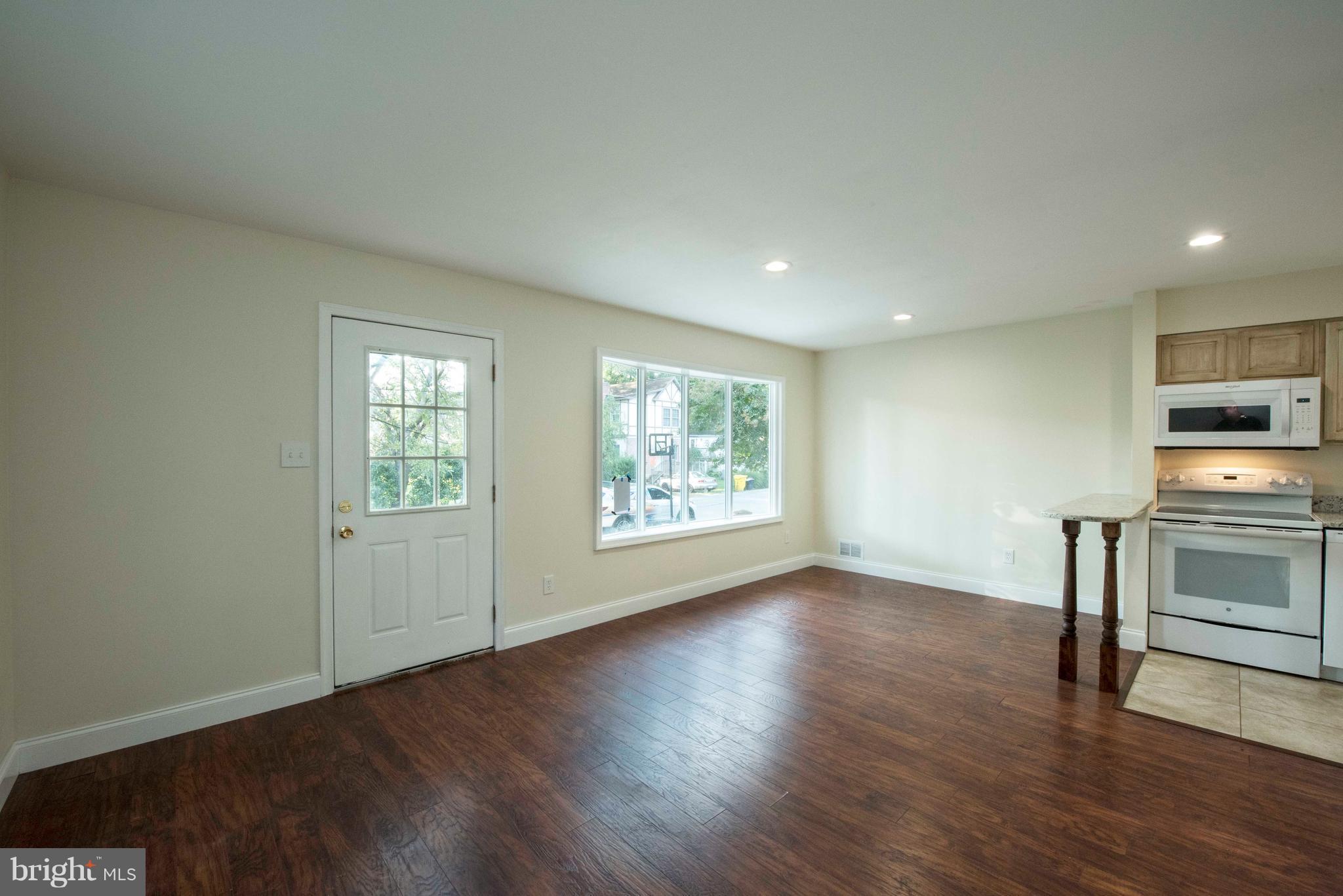 1808 Glenarm Road Edgewater, MD 21037 - Photo 6 of 29 a view of an empty room with a window and wooden floor