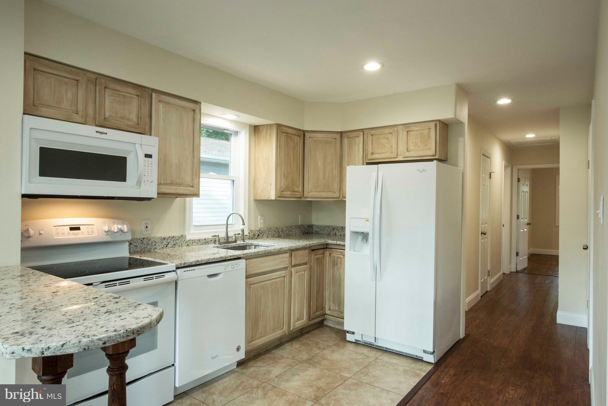 1808 Glenarm Road Edgewater, MD 21037 - Photo 7 of 29 a kitchen with stainless steel appliances granite countertop a refrigerator sink and microwave