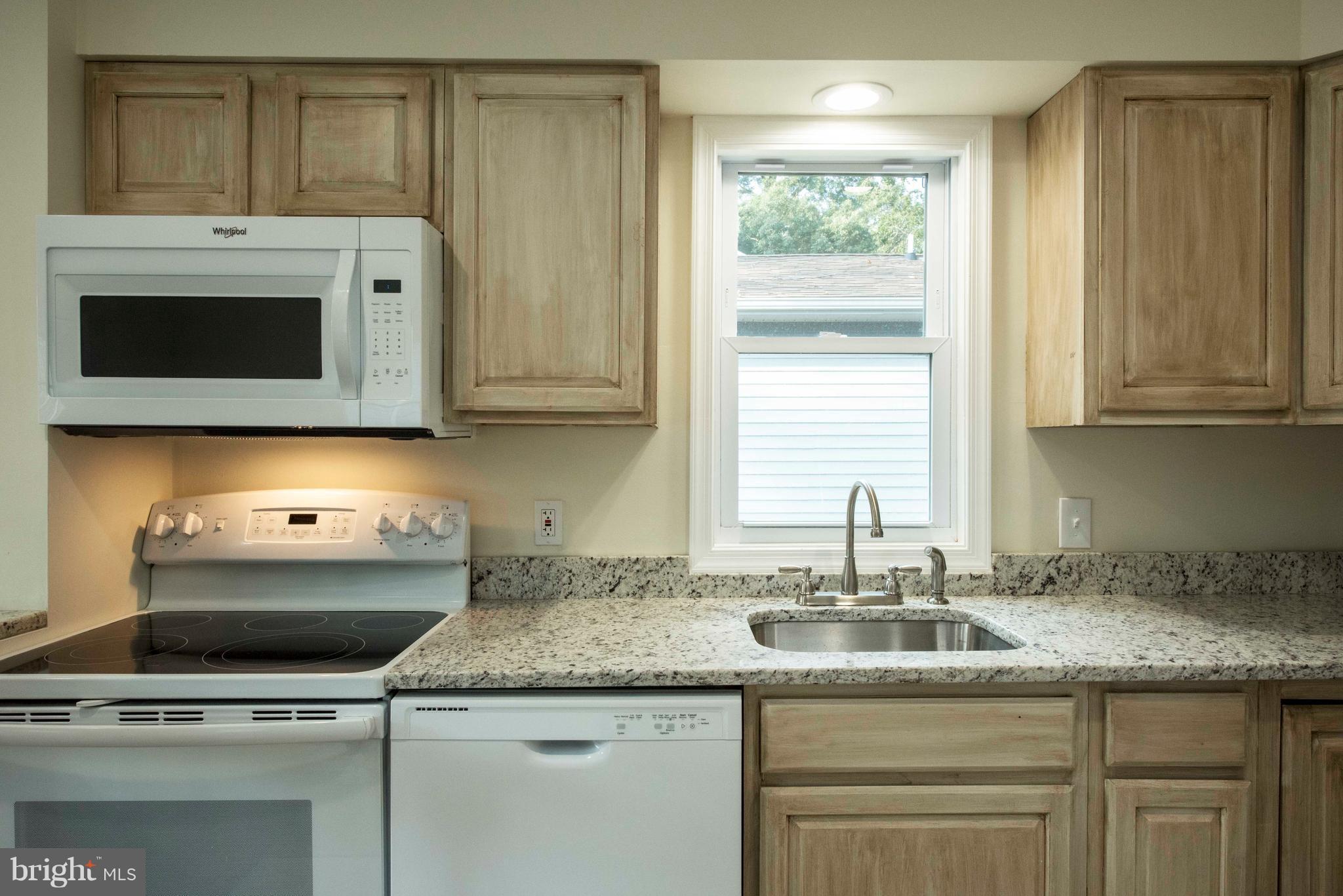 1808 Glenarm Road Edgewater, MD 21037 - Photo 9 of 29 a kitchen with granite countertop a sink stove and microwave