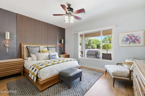 a bedroom with a bed a couch and a chandelier