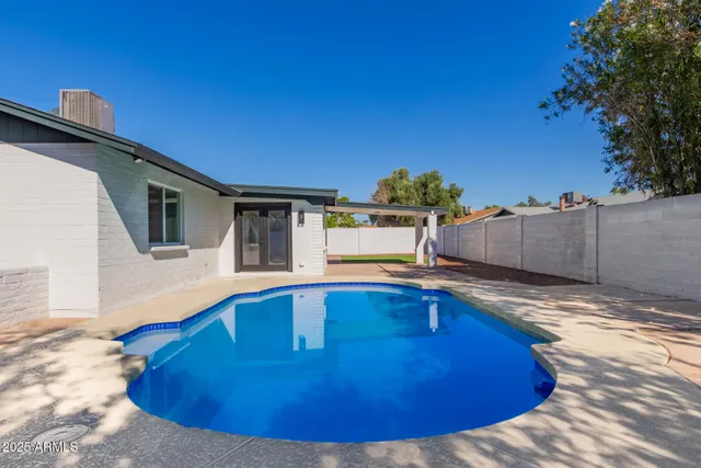 a view of a swimming pool with a chair and tables