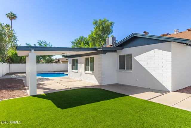 a view of a house with a yard and porch