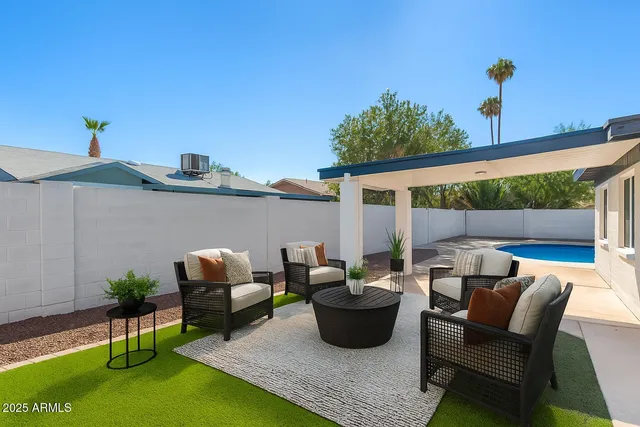 a view of a patio with table and chairs potted plants with wooden fence