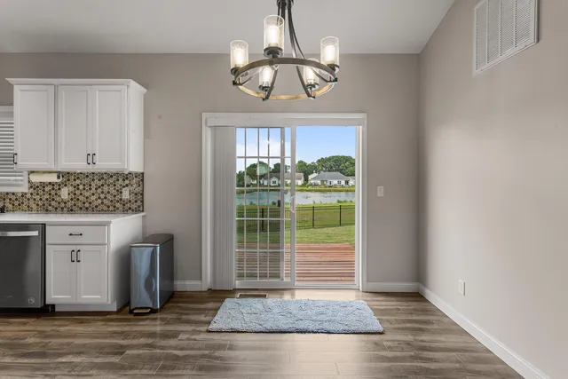 an empty room with a fireplace and windows