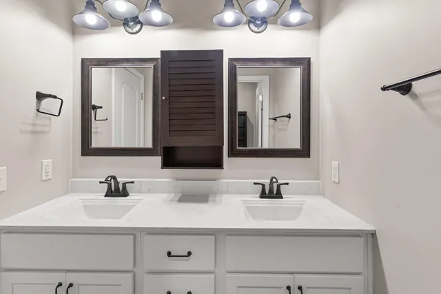 a bathroom with a sink vanity and a mirror