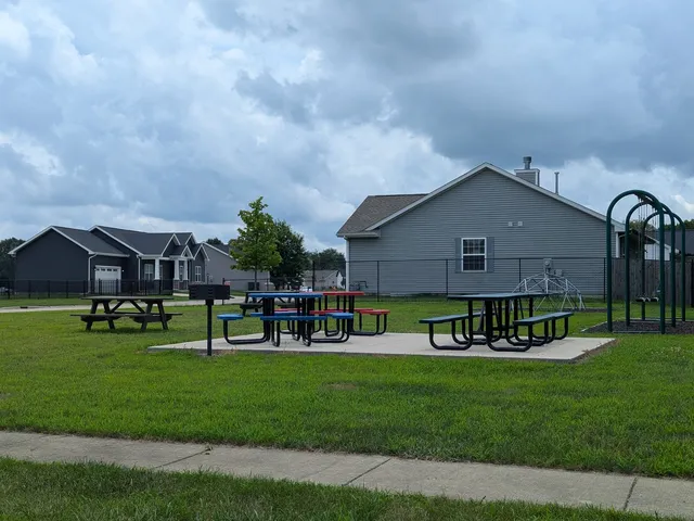 a view of a house with a big yard and large trees