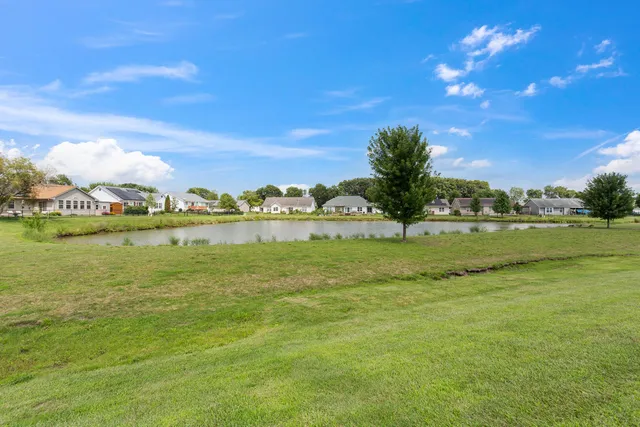 a view of a lake with houses in the background