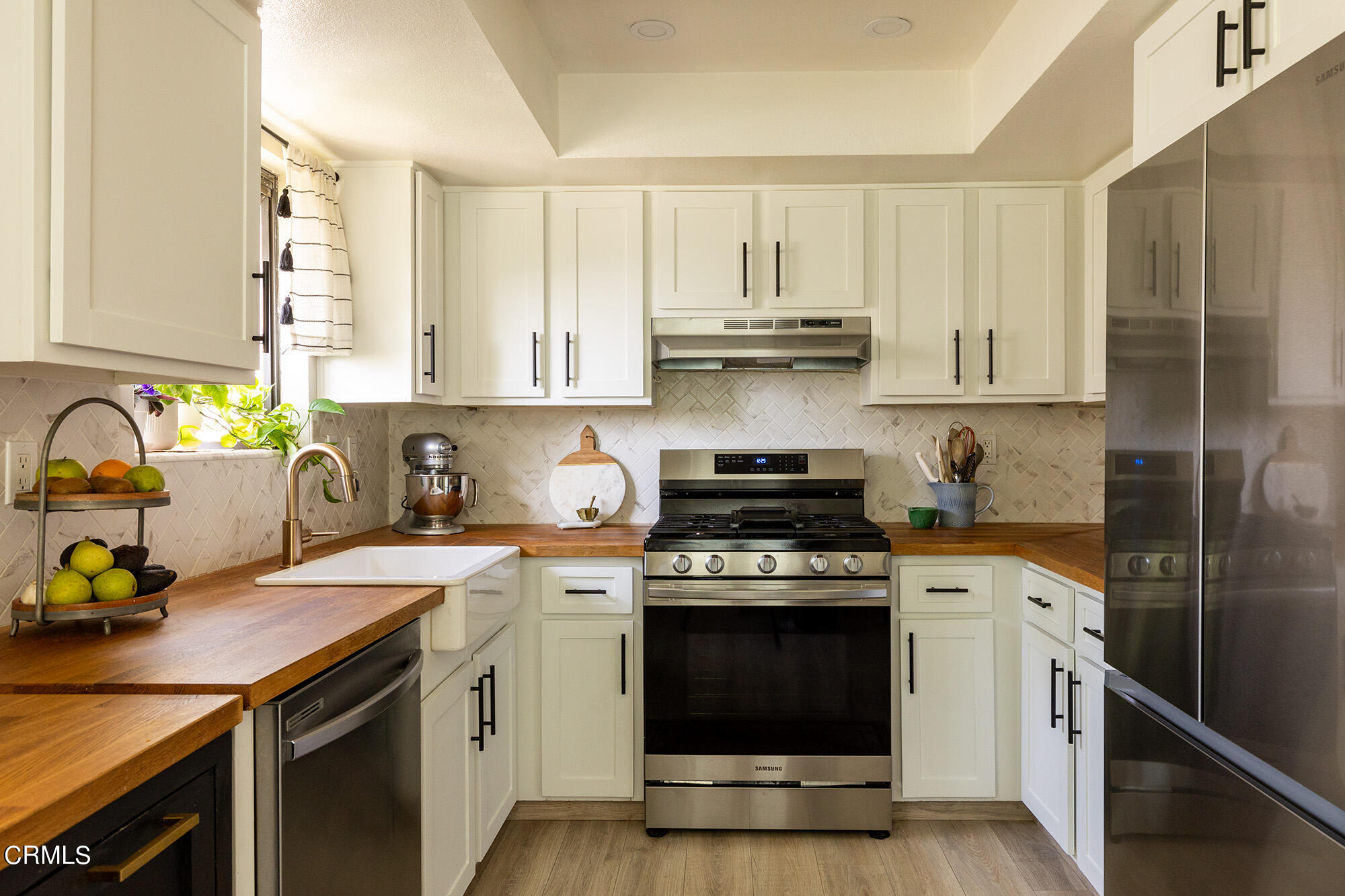 9704 Hillhaven Avenue Tujunga, CA 91042 - Photo 11 of 24 a kitchen with a stove a sink and a microwave