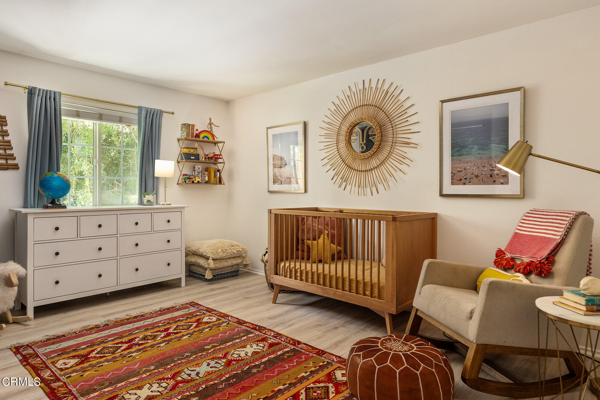 9704 Hillhaven Avenue Tujunga, CA 91042 - Photo 12 of 24 a bedroom with a baby bed a couch and two windows