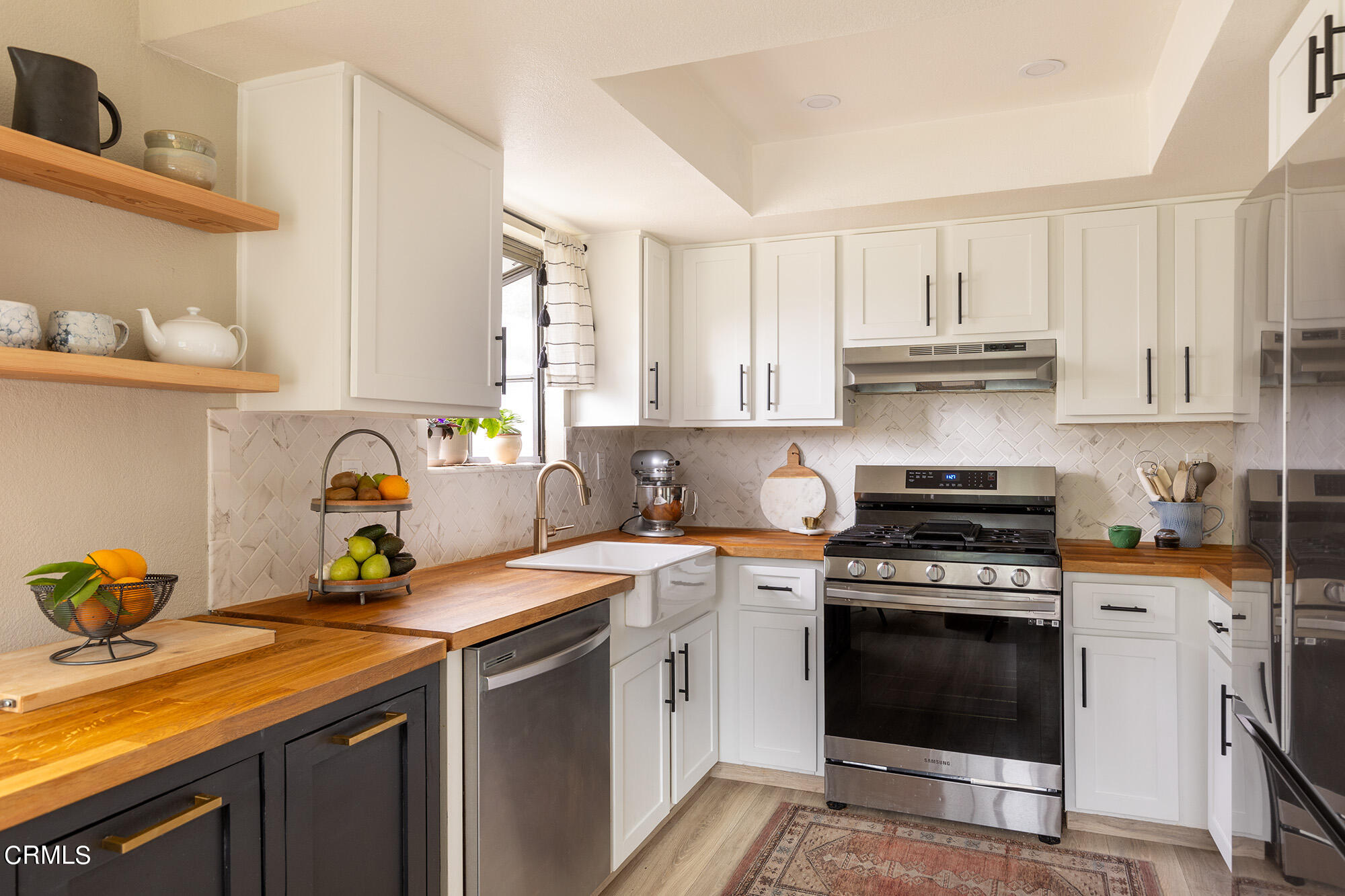 9704 Hillhaven Avenue Tujunga, CA 91042 - Photo 10 of 24 a kitchen with stainless steel appliances granite countertop a sink stove and cabinets