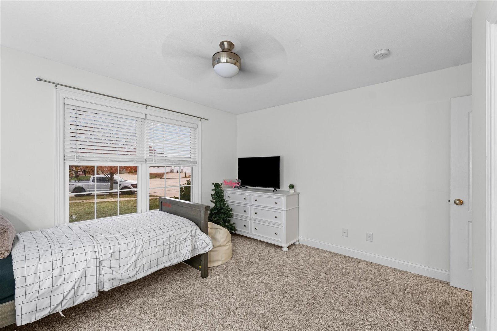 1713 Hunters Ridge Court Mahomet, IL 61853 - Photo 17 of 30 a bedroom with furniture and a flat screen tv