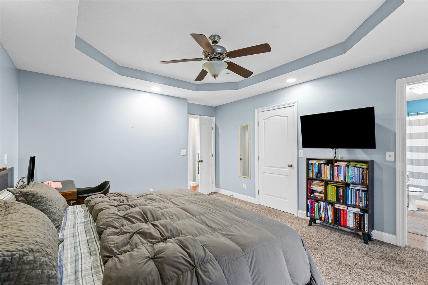 1713 Hunters Ridge Court Mahomet, IL 61853 - Photo 20 of 30 a bed room with a bed and a flat screen tv