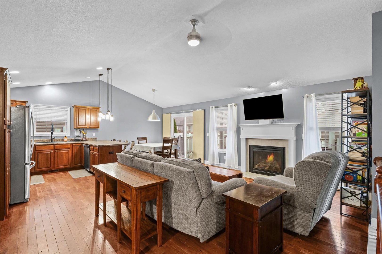 1713 Hunters Ridge Court Mahomet, IL 61853 - Photo 5 of 30 a living room with furniture fireplace and a flat screen tv