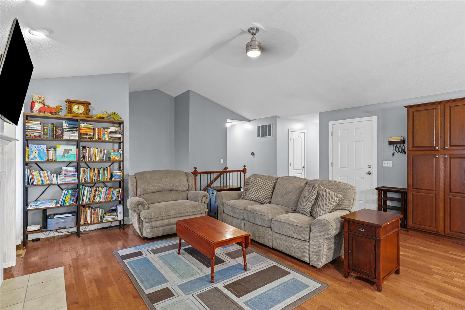 1713 Hunters Ridge Court Mahomet, IL 61853 - Photo 6 of 30 a living room with furniture workspace and a flat screen tv