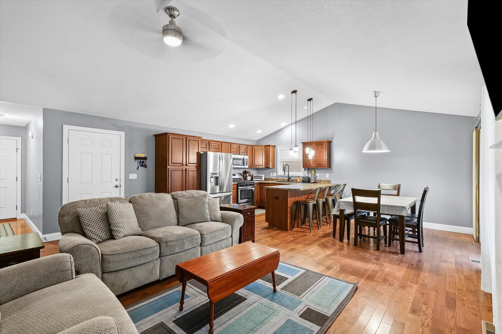 1713 Hunters Ridge Court Mahomet, IL 61853 - Photo 8 of 30 a living room with furniture a wooden floor and kitchen view