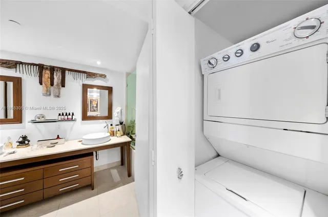 a bathroom with a granite countertop sink a toilet a mirror and shower