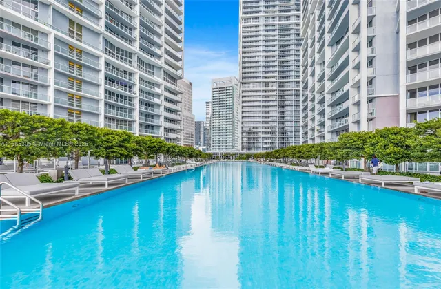 a view of a swimming pool with outdoor seating and plants