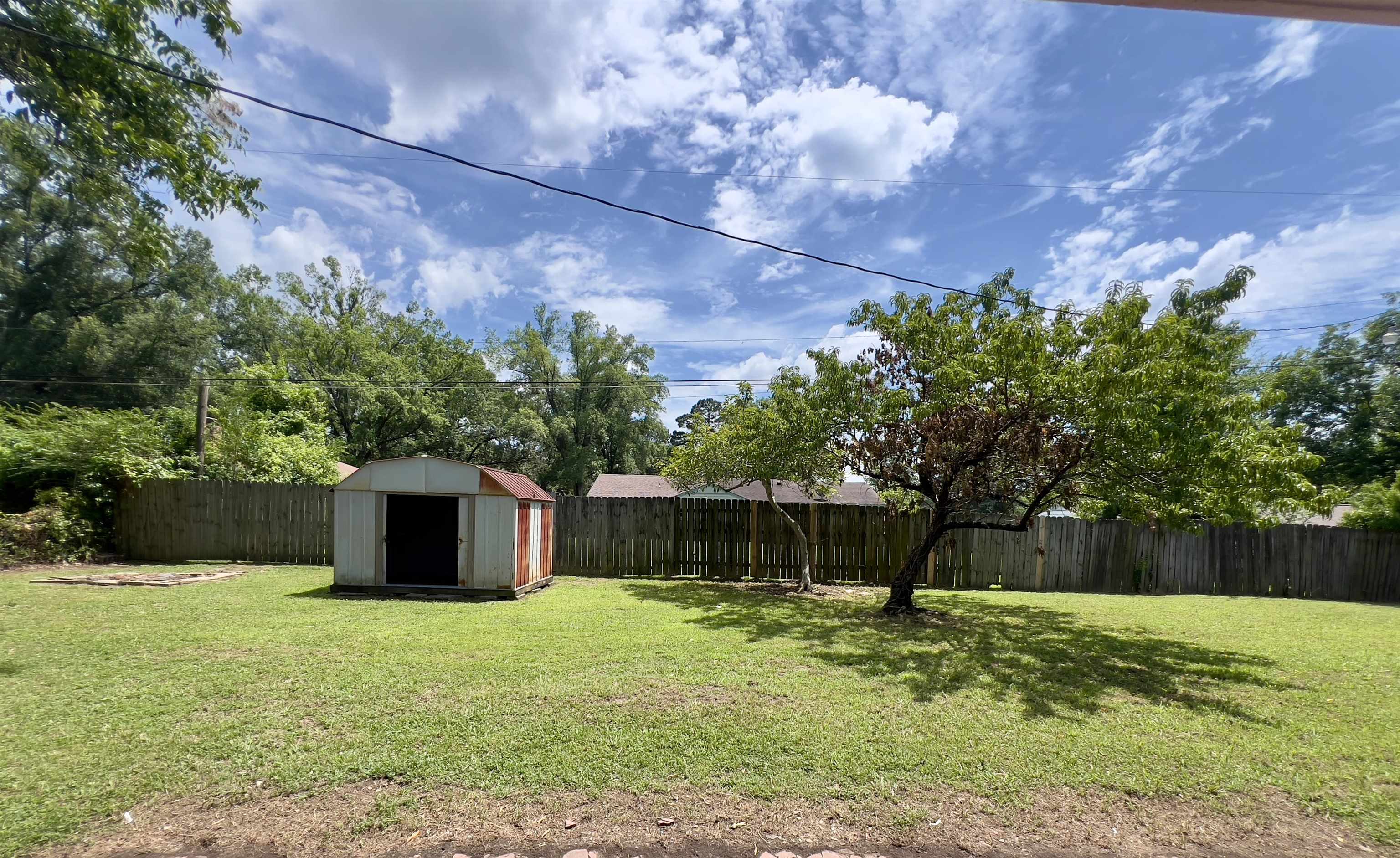 167 Clower Road Memphis, TN 38109 - Photo 18 of 20 a backyard of a house with lots of green space