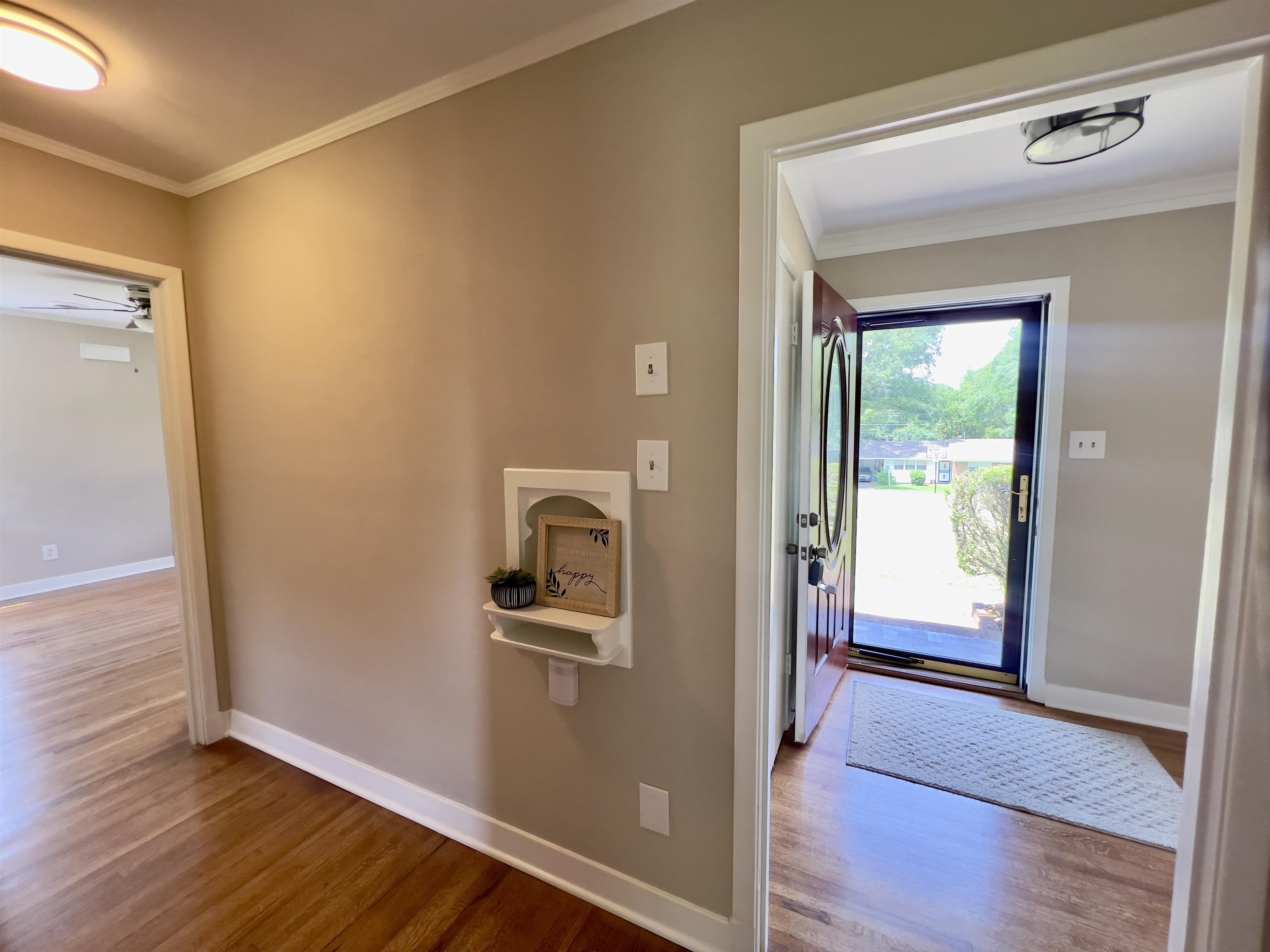 167 Clower Road Memphis, TN 38109 - Photo 5 of 20 a view of a hallway with wooden floor and a living room