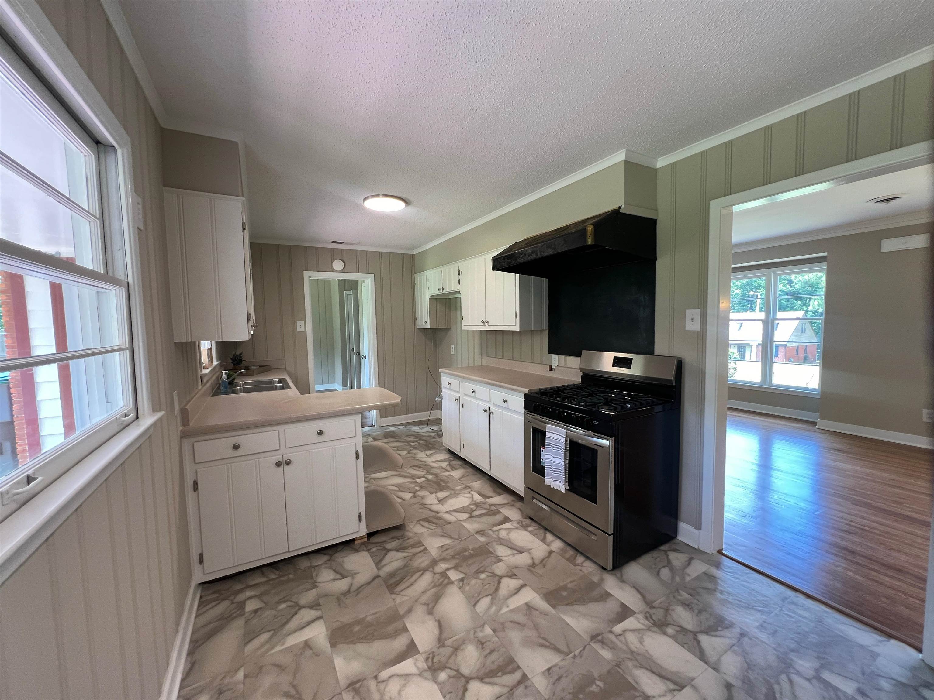 167 Clower Road Memphis, TN 38109 - Photo 7 of 20 a large kitchen with stainless steel appliances granite countertop a stove and a sink