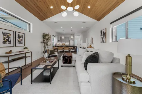 a living room with furniture and a chandelier