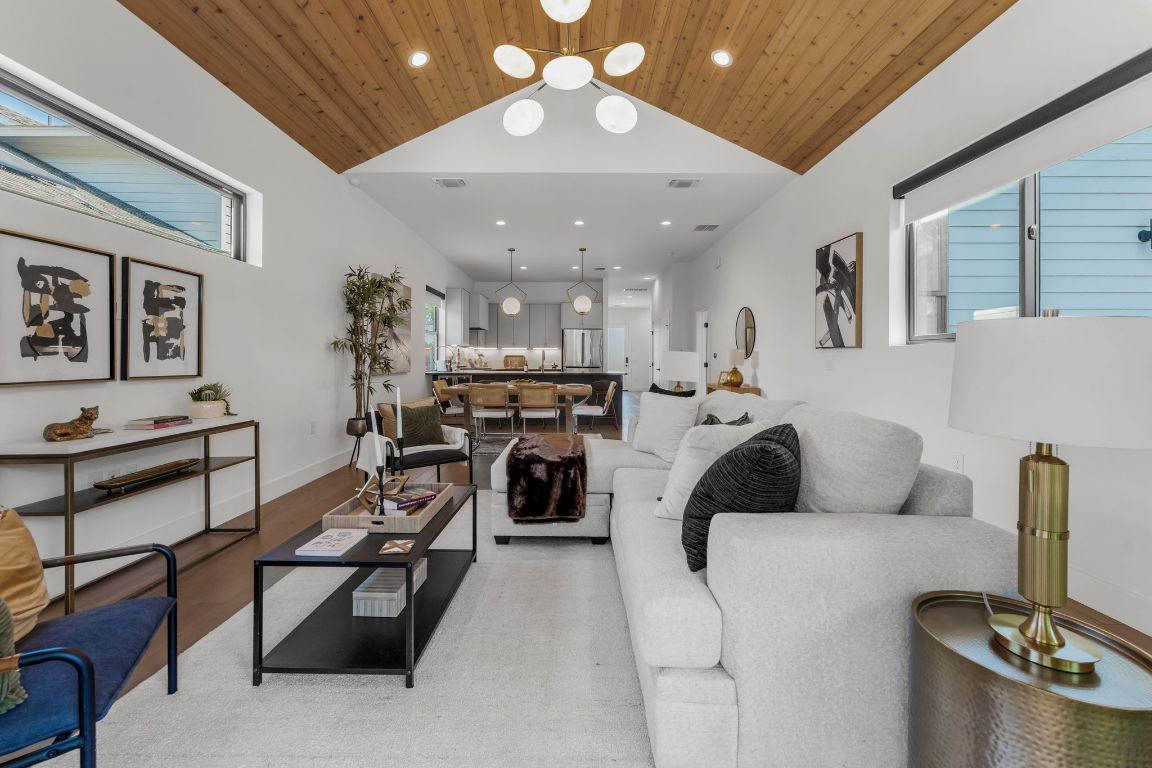 205 Ben Howell Drive Austin, TX 78704 - Photo 15 of 38 a living room with furniture and a chandelier