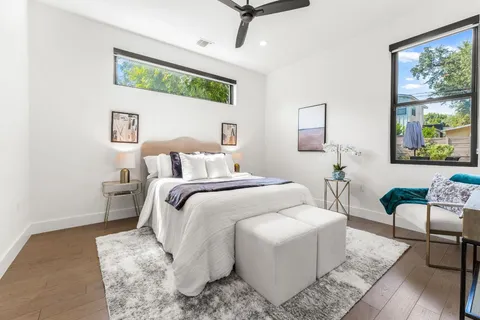 a bedroom with a bed a couch and a window