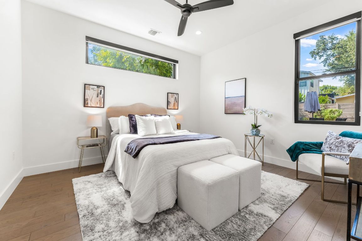 205 Ben Howell Drive Austin, TX 78704 - Photo 16 of 38 a bedroom with a bed a couch and a window