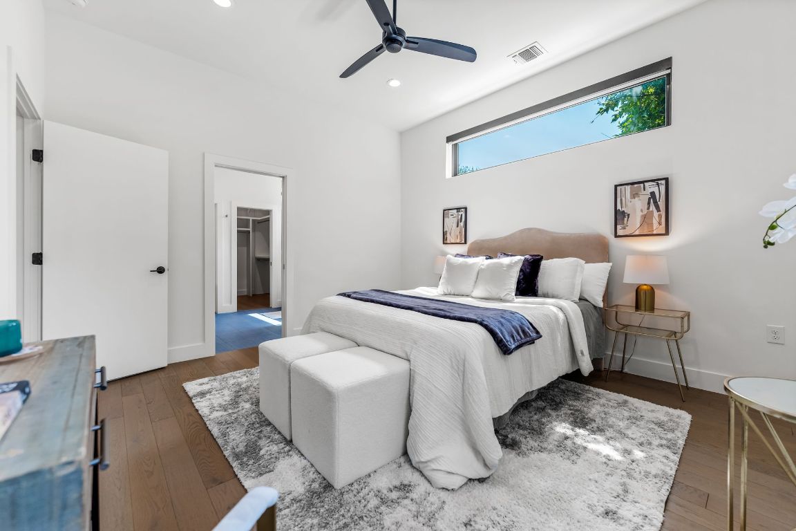 205 Ben Howell Drive Austin, TX 78704 - Photo 17 of 38 a bedroom with a bed and glass walk in closet