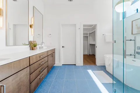 a bathroom with a double vanity sink and a mirror