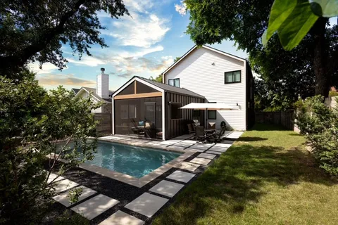 a view of house with yard and outdoor seating