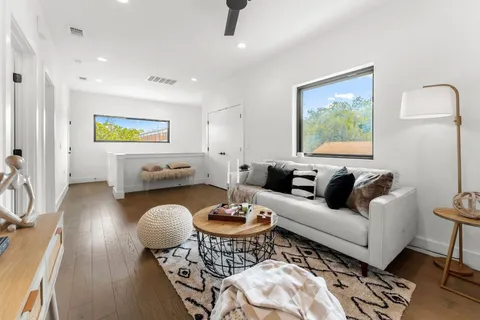 a living room with furniture a rug and a flat screen tv