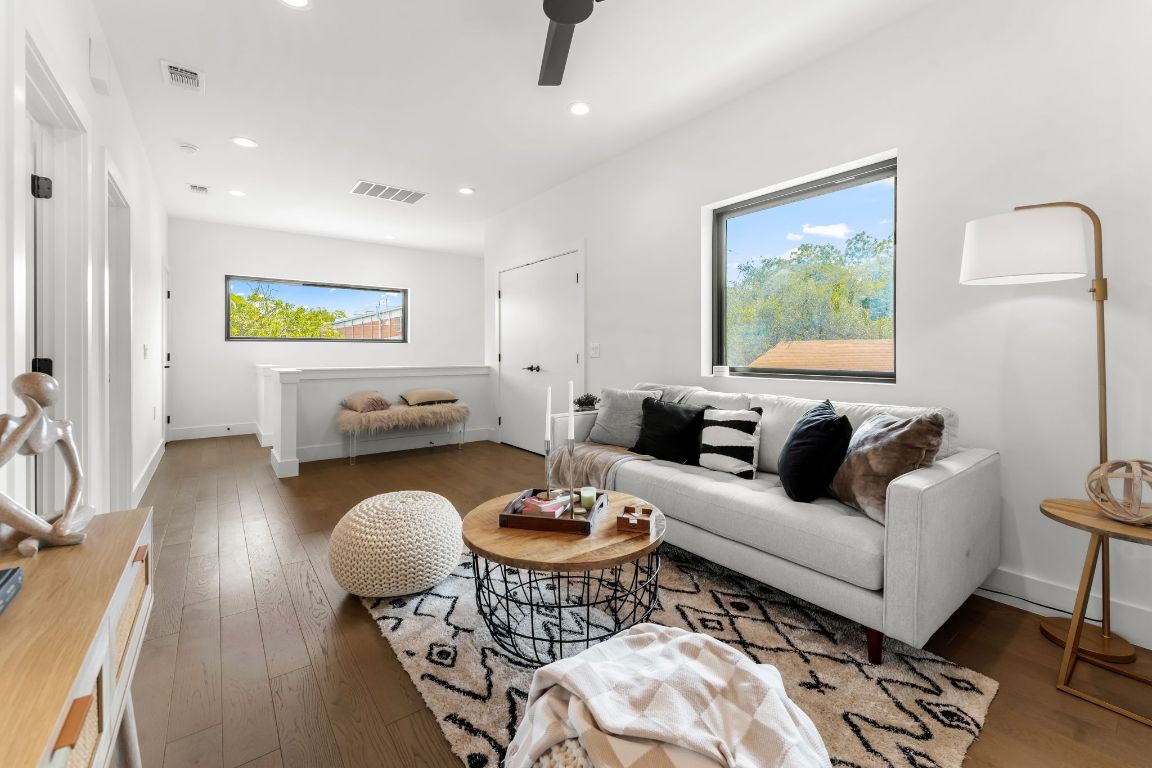 205 Ben Howell Drive Austin, TX 78704 - Photo 23 of 38 a living room with furniture a rug and a flat screen tv