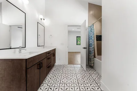 a bathroom with a sink a toilet and mirror