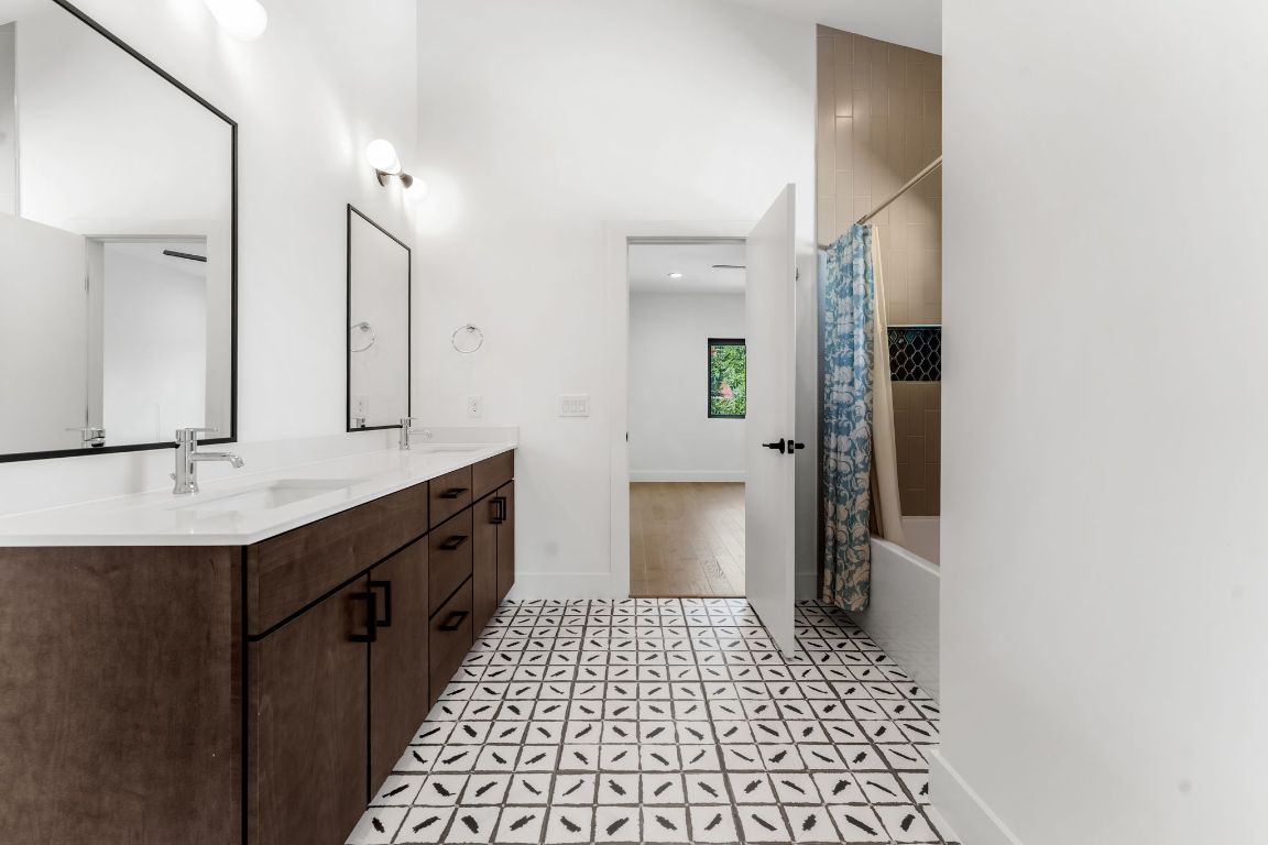205 Ben Howell Drive Austin, TX 78704 - Photo 26 of 38 a bathroom with a sink a toilet and mirror