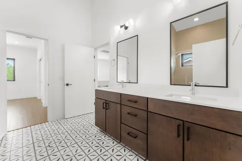 a bathroom with a double vanity sink and mirror