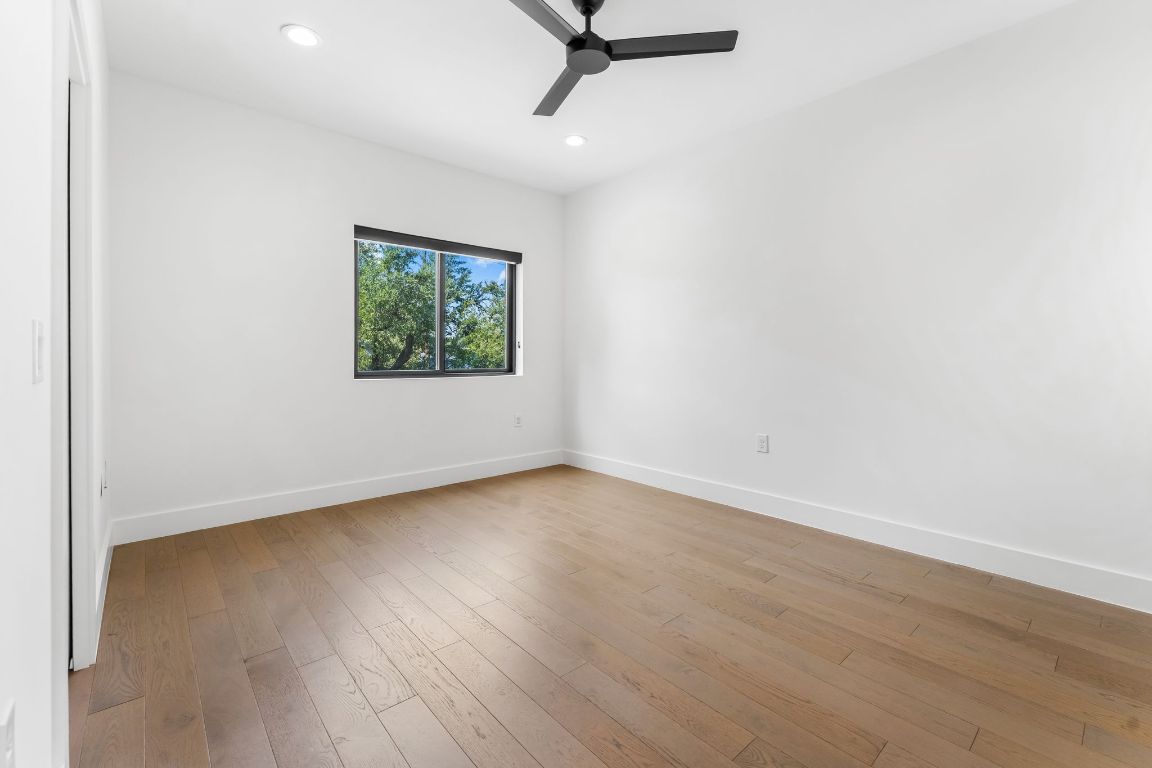 205 Ben Howell Drive Austin, TX 78704 - Photo 28 of 38 an empty room with wooden floor and windows