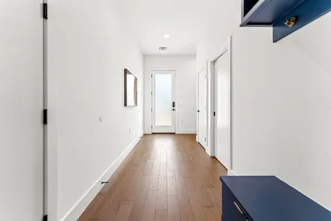 a view of a hallway with wooden floor