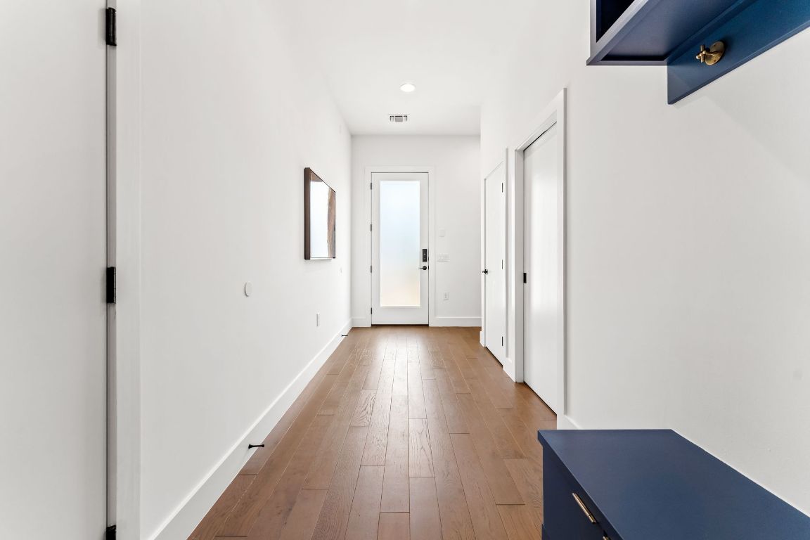 205 Ben Howell Drive Austin, TX 78704 - Photo 30 of 38 a view of a hallway with wooden floor