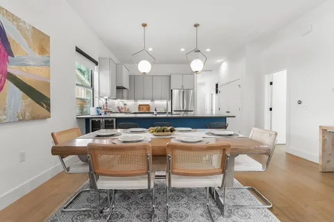 a kitchen with a dining table and chairs