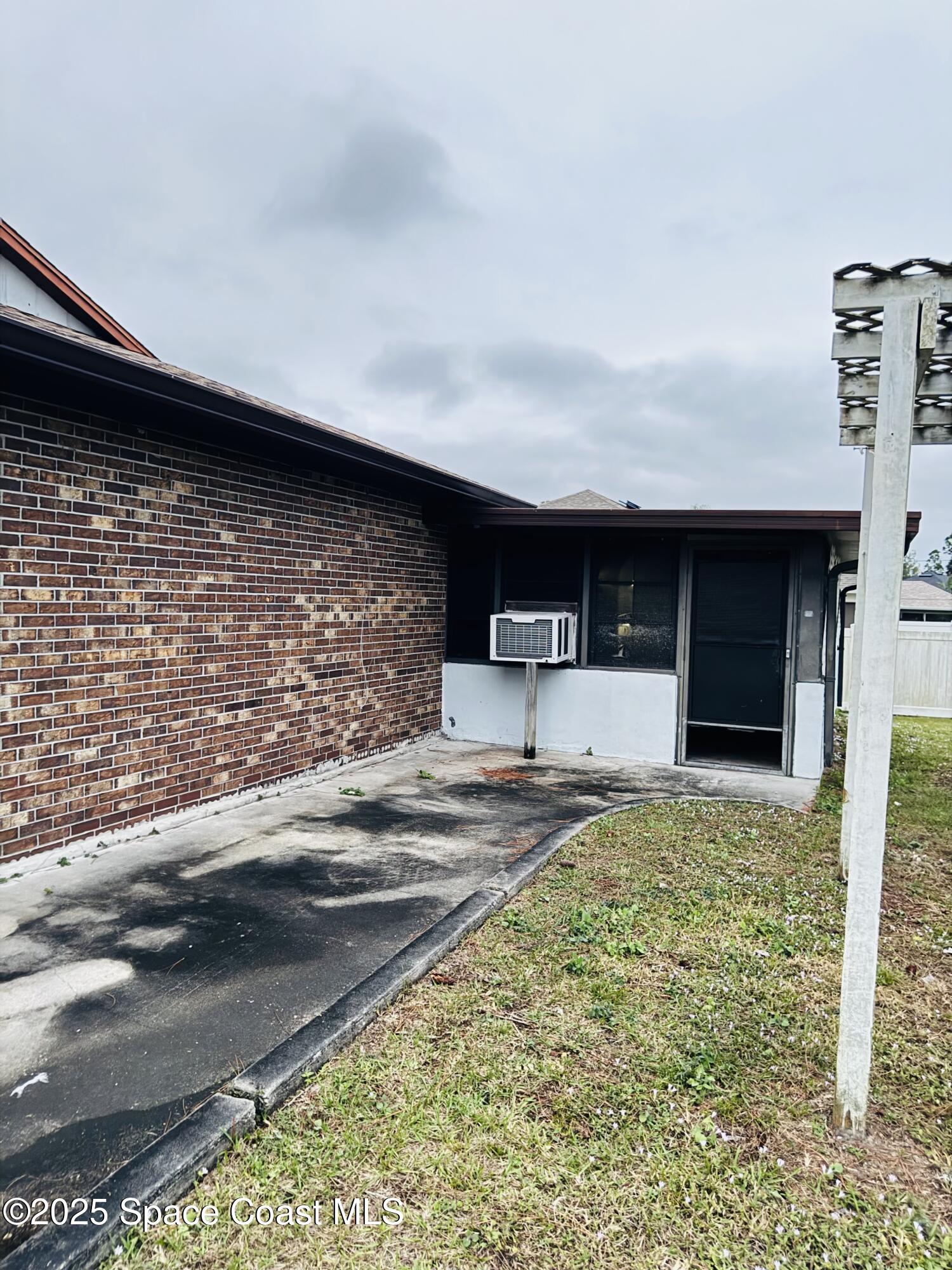 255 Abalone Road Northwest Palm Bay, FL 32907 - Photo 11 of 11 a front view of a house with a yard
