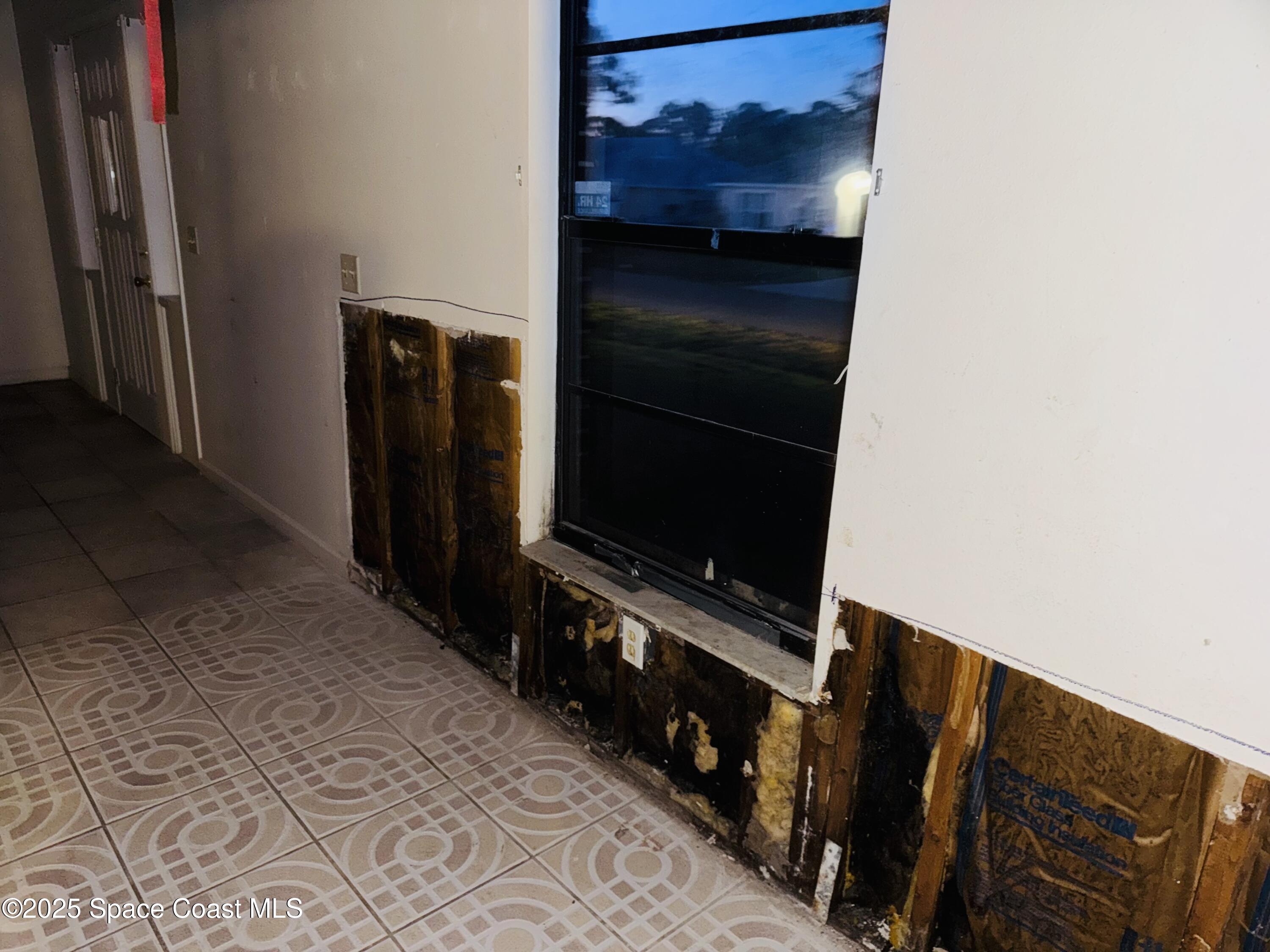 255 Abalone Road Northwest Palm Bay, FL 32907 - Photo 4 of 11 a living room with wooden floor and a flat screen tv