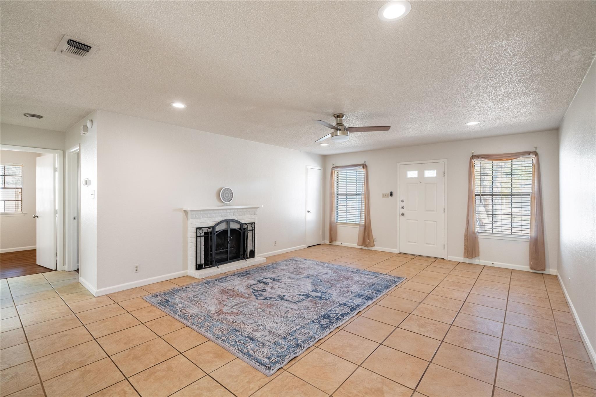 3800 Foust Trail, Unit B Georgetown, TX 78628 - Photo 3 of 16 A classic fireplace and tiled flooring define this inviting living space.