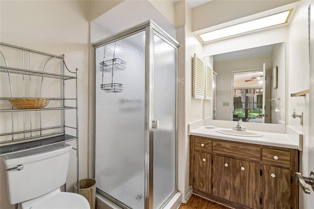 11340 Carriage Hill Drive, Unit 4 Port Richey, FL 34668 - Photo 16 of 36 a bathroom with a granite countertop sink toilet and shower
