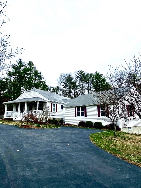 48 Pine Street Rochester, MA 02770 - Photo 1 of 39 a front view of a house with a yard table and chairs