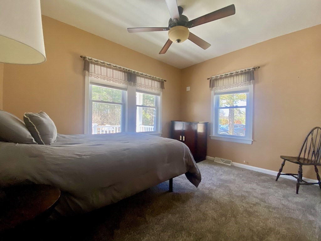 48 Pine Street Rochester, MA 02770 - Photo 27 of 39 a bedroom with a bed two lamps and a window