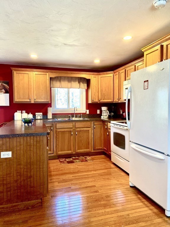 48 Pine Street Rochester, MA 02770 - Photo 33 of 39 a kitchen with stainless steel appliances granite countertop a stove a sink and a refrigerator