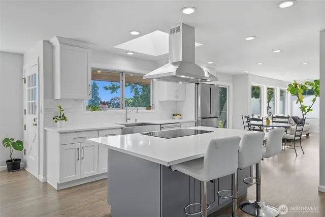 a kitchen with lots of counter space a sink and appliances