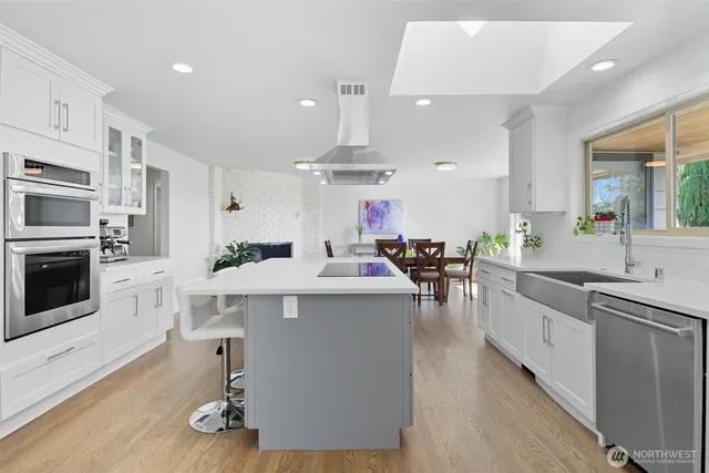 a kitchen with counter top space a sink cabinets and appliances