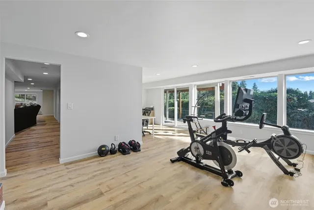 a view of a room with gym equipment and floor to ceiling window